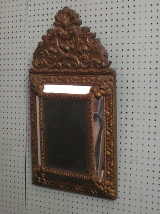 A Continental style cushion shaped plate mirror contained in an embossed gilt metal frame 24"