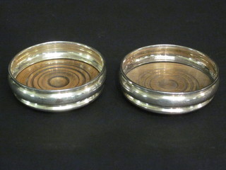 A pair of modern circular silver bottle coasters 3"