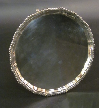 A circular silver salver with bracketed border, raised on 3 hoof  feet, London 1927, 22 1/2 ozs ILLUSTRATED
