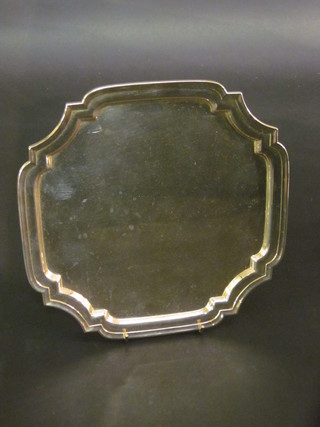 A square silver plated salver with bracketed border, raised on  hoof supports 10"