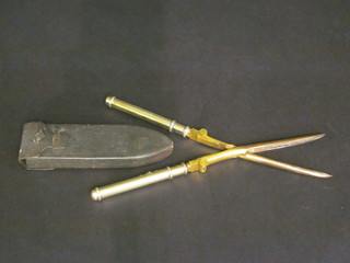 A pair of Edwardian gilt metal travelling curling tongs with  silver gilt handles, London 1909, contained in a leather carrying  case