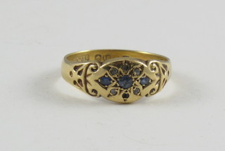 An 18ct gold dress ring set blue stones