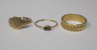 A gold dress ring, stone missing, together with a gilt metal  mourning band and a gold signet ring, cut,
