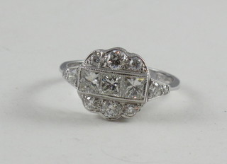 A lady's 18ct white gold dress ring set 3 diamonds surrounded by numerous other diamonds, approx 1.35ct