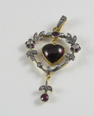 A gold brooch/pendant set diamonds and a cabouchon cut garnet