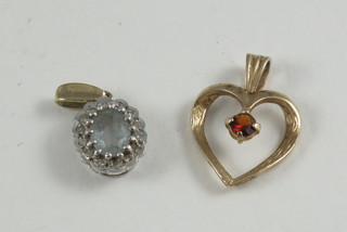 A gold heart shaped pendant set a garnet together a 9ct gold pendant set an oval cut amethyst
