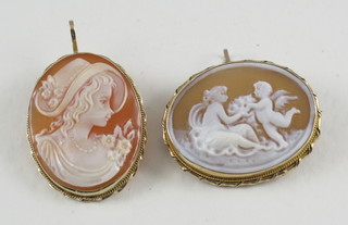 2 shell carved cameo brooches contained in 9ct gold mounts