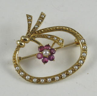 A gold bar brooch set pink stones and demi-pearls