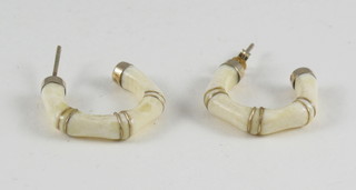 A pair of gold and ivory earrings