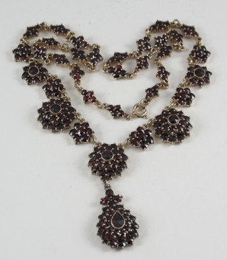 A garnet and yellow metal necklet