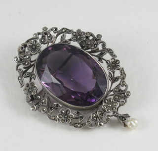 A silver pendant/brooch mounted set an amethyst and marcasite