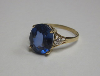 A gold dress ring set an oval cut sapphire 2 diamonds to the shoulders