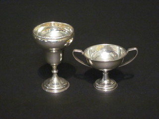 A miniature silver plated twin handled trophy cup and 1 other