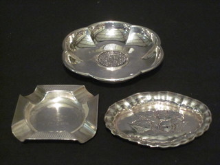A circular silver ashtray 2", an oval pin tray decorated angels 3" and a Continental dish inset a coin 3 1/2", 2 ozs