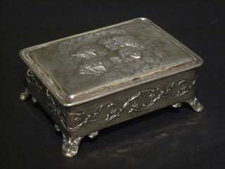 An Edwardian embossed silver trinket box, the lid decorated  Angels, raised on panel feet, Birmingham 1903, 4 1/2"