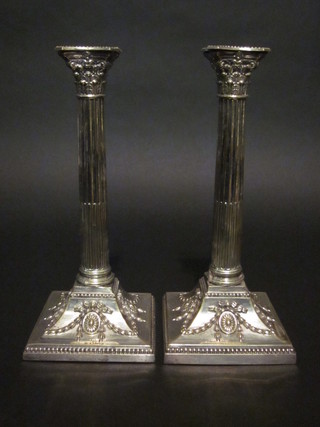 A pair of Adam style reeded silver plated candlesticks with Corinthian capitals 12"