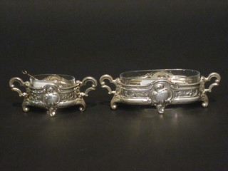 A pair of Continental embossed white metal twin handled oval  salts