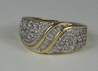 A gold dress ring set baguette cut diamonds surrounded by  diamonds