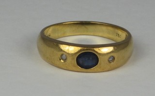 An 18ct gold dress ring set oval cut blue stones supported by 2  white stones