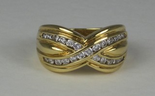 An 18ct gold dress ring set cross-over diamonds
