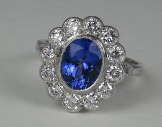 A lady's 18ct white gold dress ring set an oval Tanzanite  surrounded by numerous diamonds approx 1.15/2.25ct