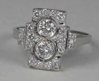 A lady's 18ct white gold dress ring set 2 circular diamonds surrounded by numerous diamonds approx 1ct