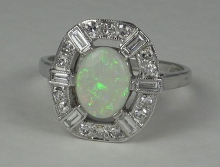 A lady's 18ct white gold dress ring set an oval cut opal supported  by baguette and round cut diamonds