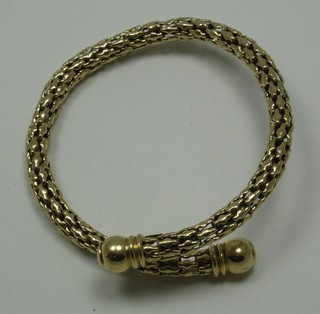 A gilt metal torque bracelet