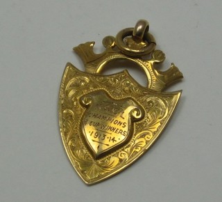 A gold watch chain medallion