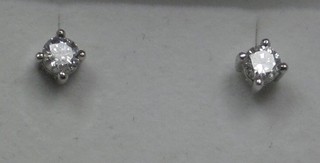 A pair of diamond claw set ear studs, approx 0.65ct