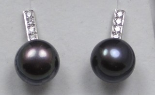 A pair of pearl and diamond drop ear studs
