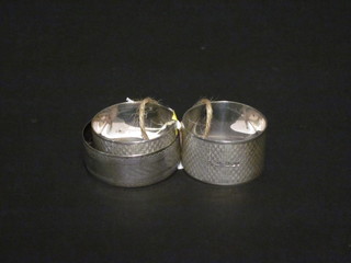 A matched pair of silver napkin rings, Birmingham 1931 and  1932, together with a silver bangle 2 ozs