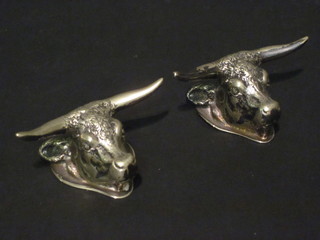A pair of silver plated knife rests in the form of bulls heads