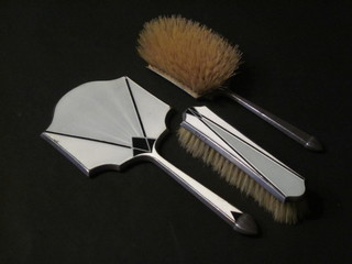 An Art Deco 3 piece silver and enamelled backed dressing table set with hand mirror, hair brush and clothes brush, Birmingham  1931 and 1932