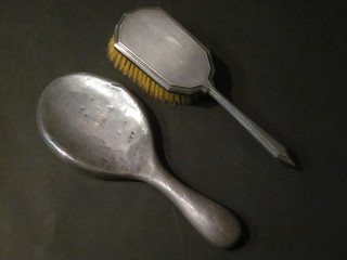 A silver backed hand mirror and hair brush