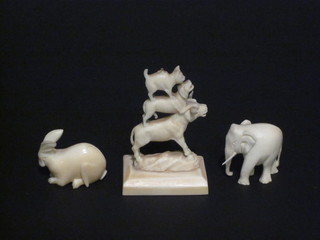 A carved ivory figure of 3 balancing animals 2", a carved figure  of a hare 1", do. elephant 1"