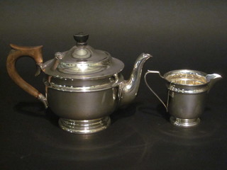 A circular 2 piece silver teaset comprising teapot and cream jug, Sheffield 1935 and 1936