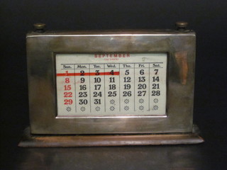 A silver perpetual calendar, marks rubbed