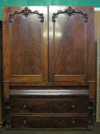 A William IV mahogany linen press with moulded cornice ,f, the interior fitted 2 trays, the base fitted 1 long secret drawer above 2  long drawers with scroll decoration to the sides 54"