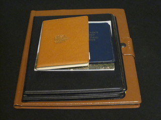 A brown album of various coins and 3 proof sets of British coins