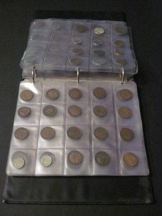 A black album containing a collection of various coins