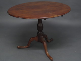 An 18th/19th Century circular snap top fruitwood tea table, raised on a turned column and tripod base 38"
