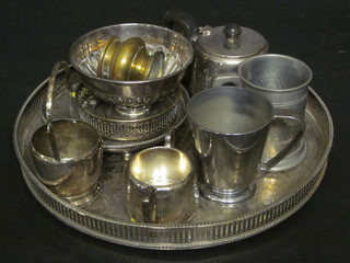 A circular silver plated galleried tea tray and a small collection of plated items