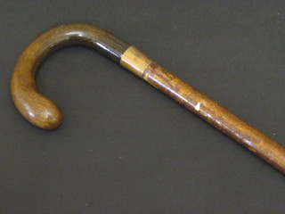 An Edwardian walking cane with gilt metal band marked Bigg,  with rhino horn handle