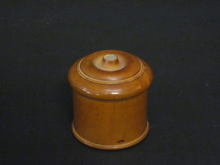 A cylindrical turned wooden jar containing a collection of studs  2"