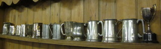 A collection of silver plated and pewter pint tankards