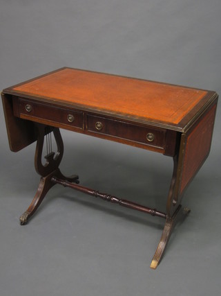 A Georgian style mahogany sofa table with brown inset writing surface, fitted 2 drawers raised on lyre supports with H framed  stretcher 35"