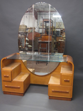 An Art Deco oak dressing table with arched plate mirror, the  base fitted 2 short and 2 long drawers 46"