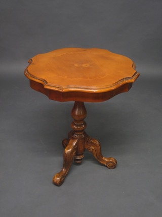A circular mahogany wine table, raised on a pillar and tripod  base, 21"