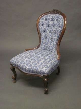 A Victorian rosewood carved spoon back chair with upholstered  seat and back, raised on cabriole supports